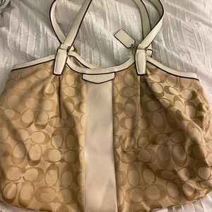 white and tan coach bag
